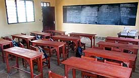 Each of the first two completed classrooms is furnished with 12 wooden desks and 24 chairs.