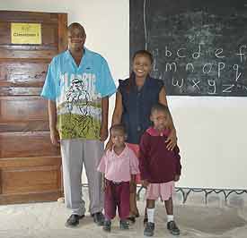 Jenny (right) with Joe are visiting the small Brian with his mother at their home in Kenya.